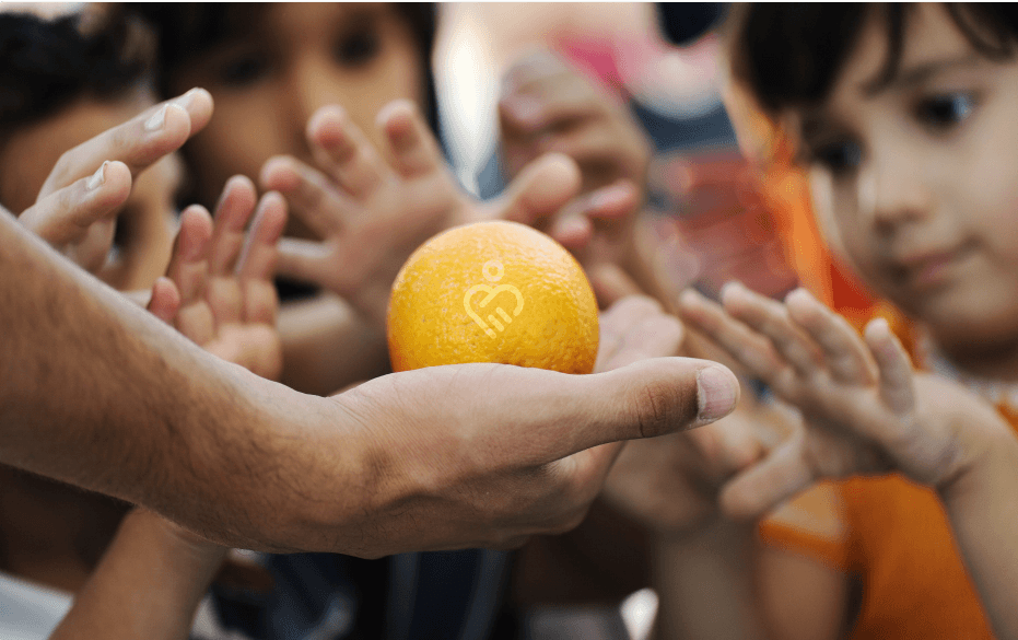 orange-in-hand-with-kids